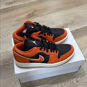 Jordan women’s Black and Orange Low-Top Sneakers